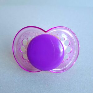 Transparent purple PRU pacifier shield with a purple button.