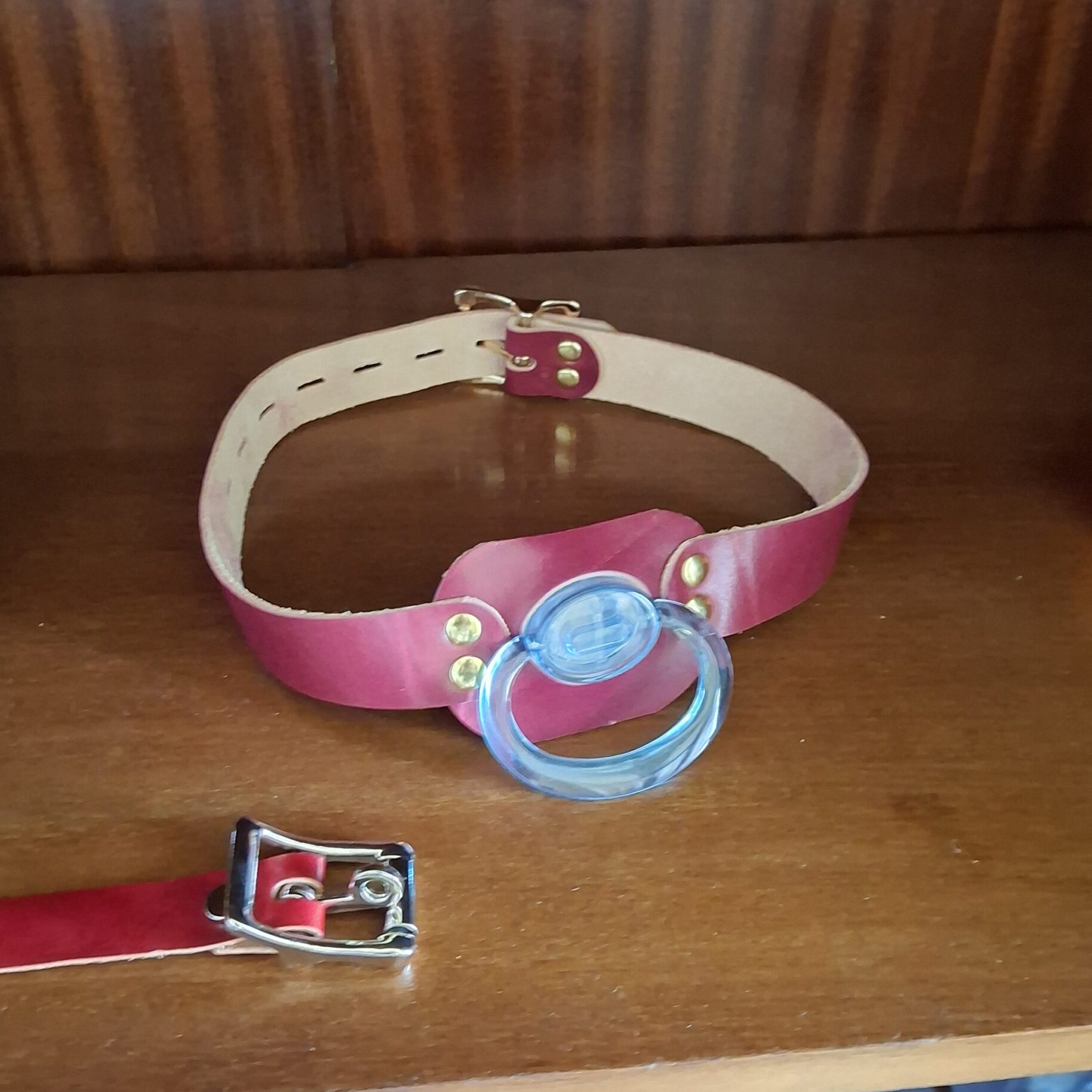 Pink leather strap with a blue pacifier shield in the doodoo showroom.