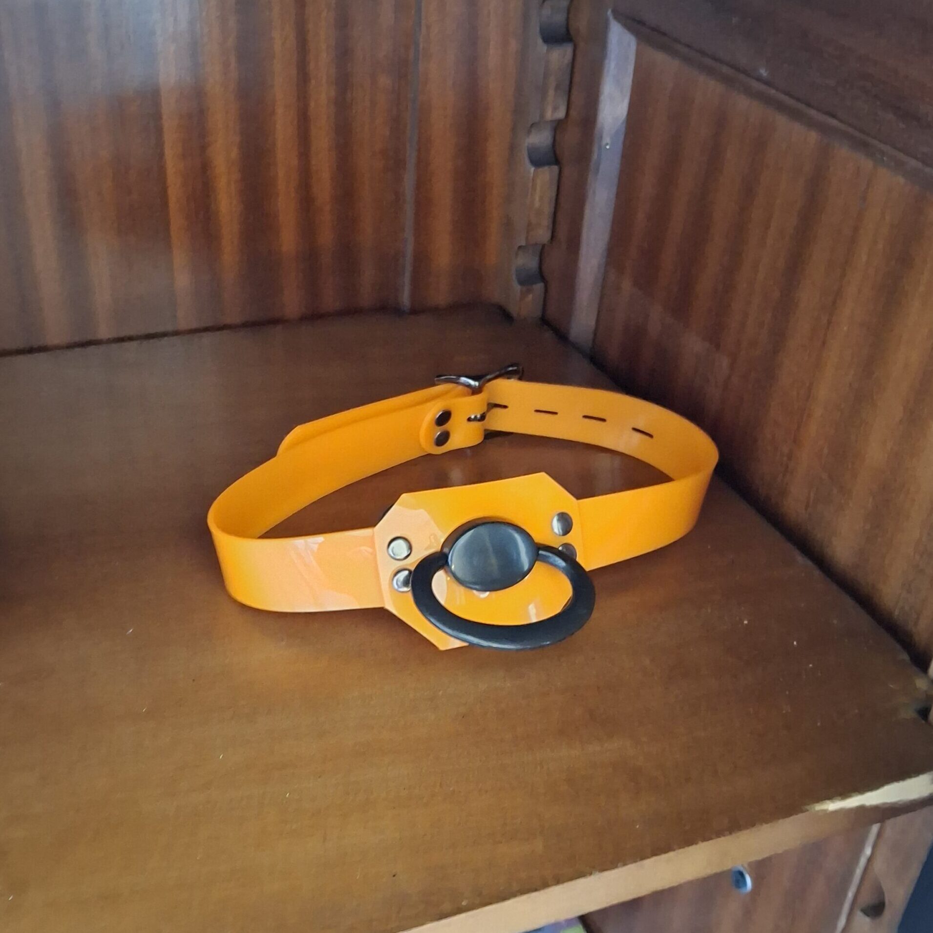 Yellow leather strap with a blue pacifier shield in the doodoo showroom.