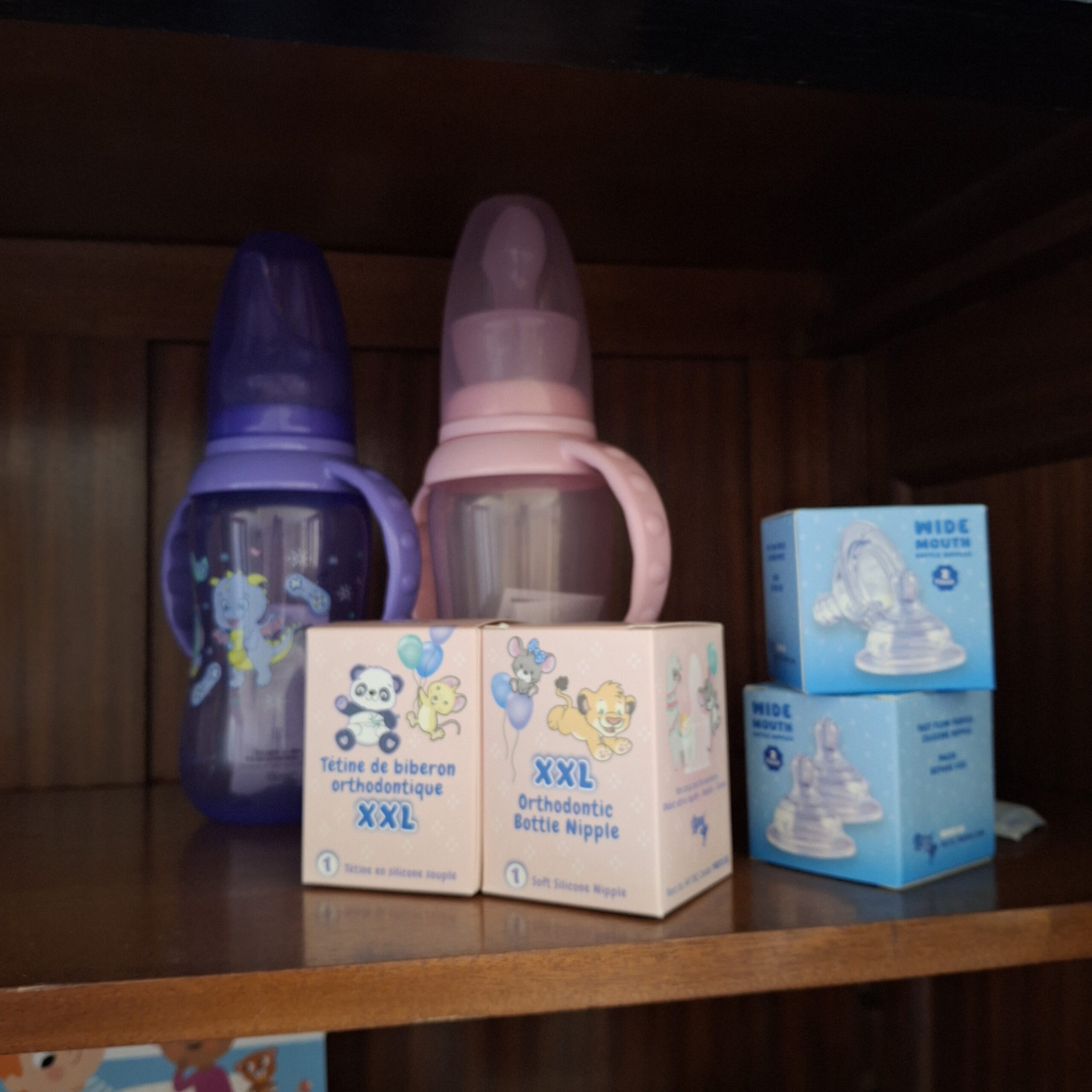 Bottles with handles and boxes of replacement teats in the doodoo showroom.