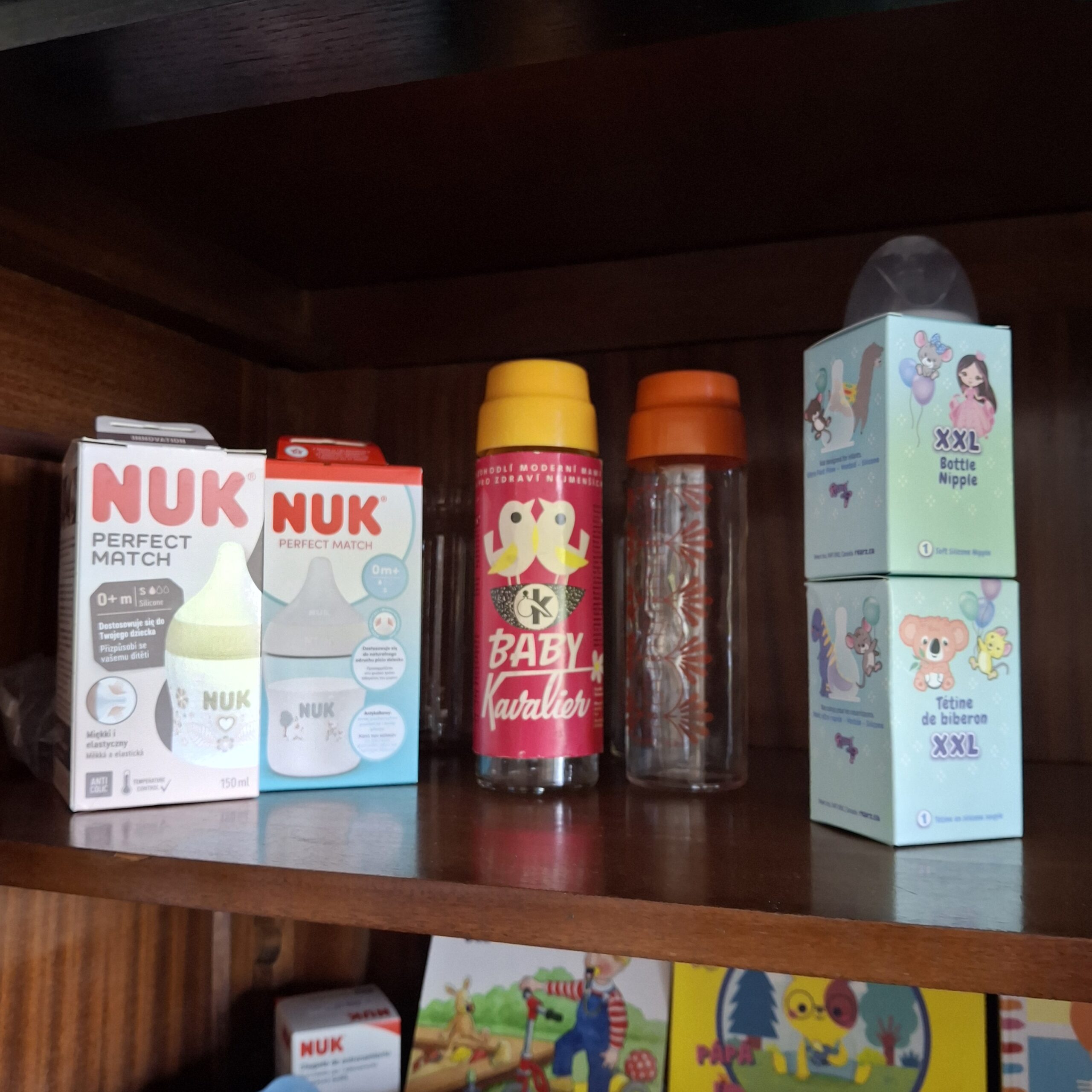 Bottles and NUK pacifier packaging on a shelf in the doodoo showroom.